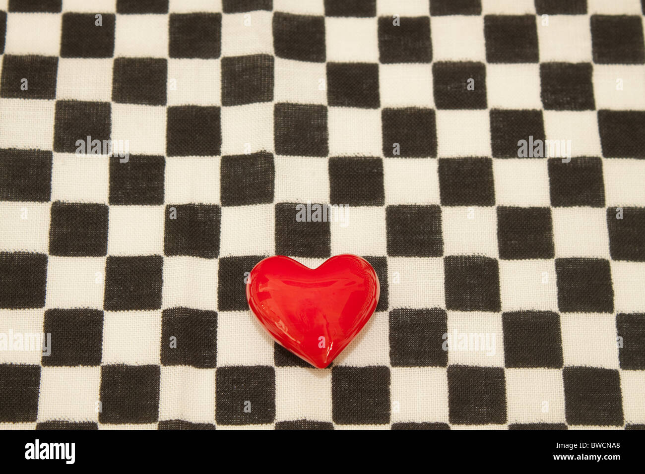 Red heart with black and white checkered background Stock Photo - Alamy