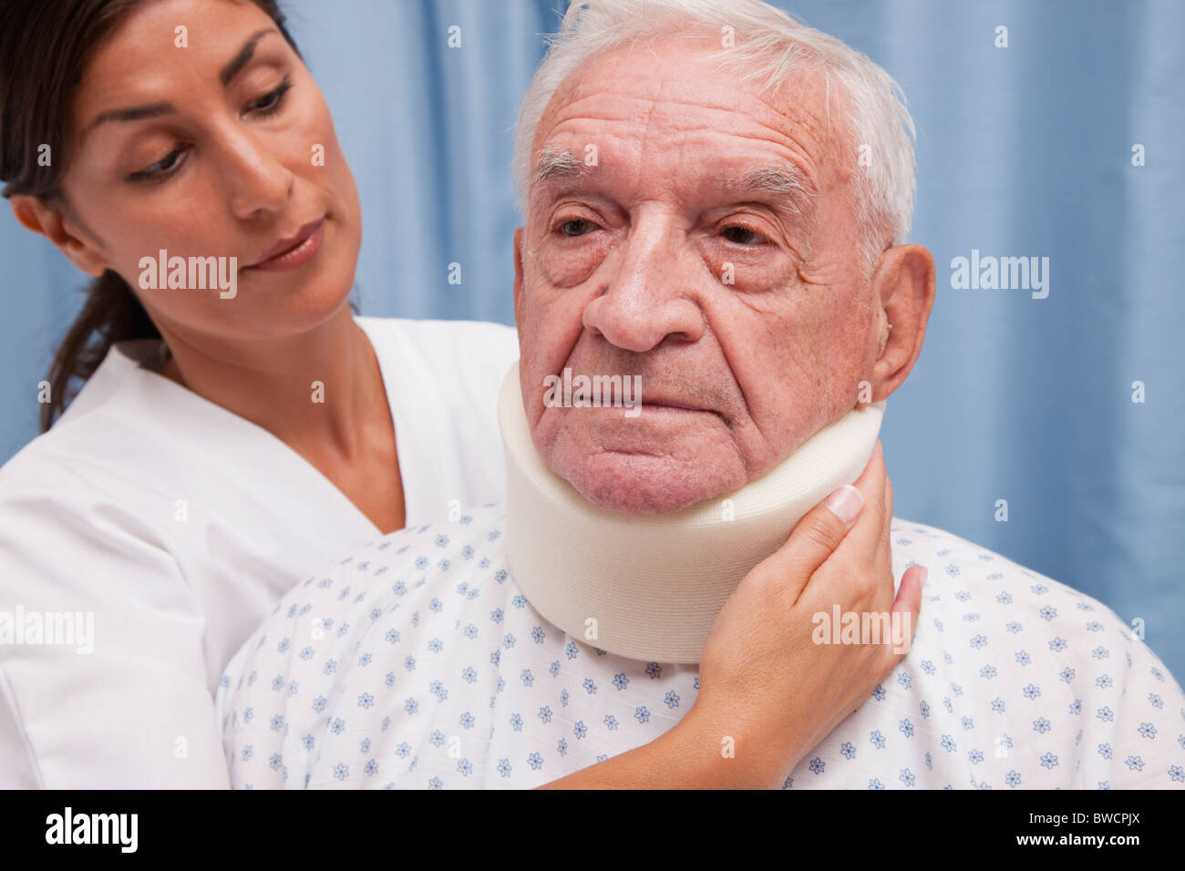 USA, Illinois, Metamora, Female doctor fastening neck brace on senior man's neck Stock Photo