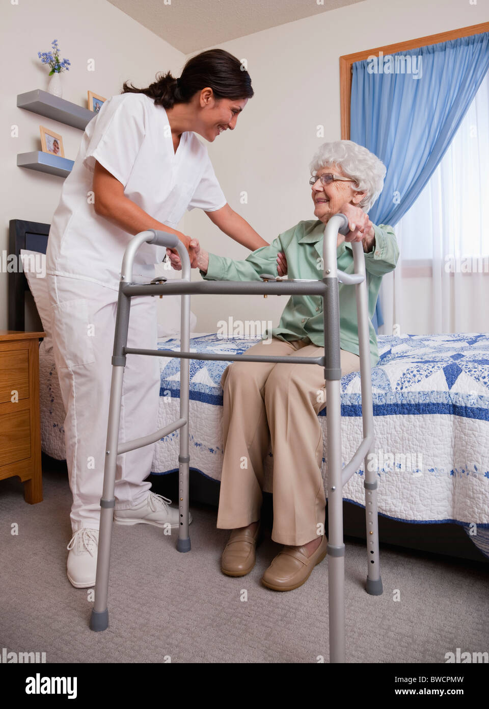USA, Illinois, Metamora, Nurse helping senior woman with walker Stock Photo