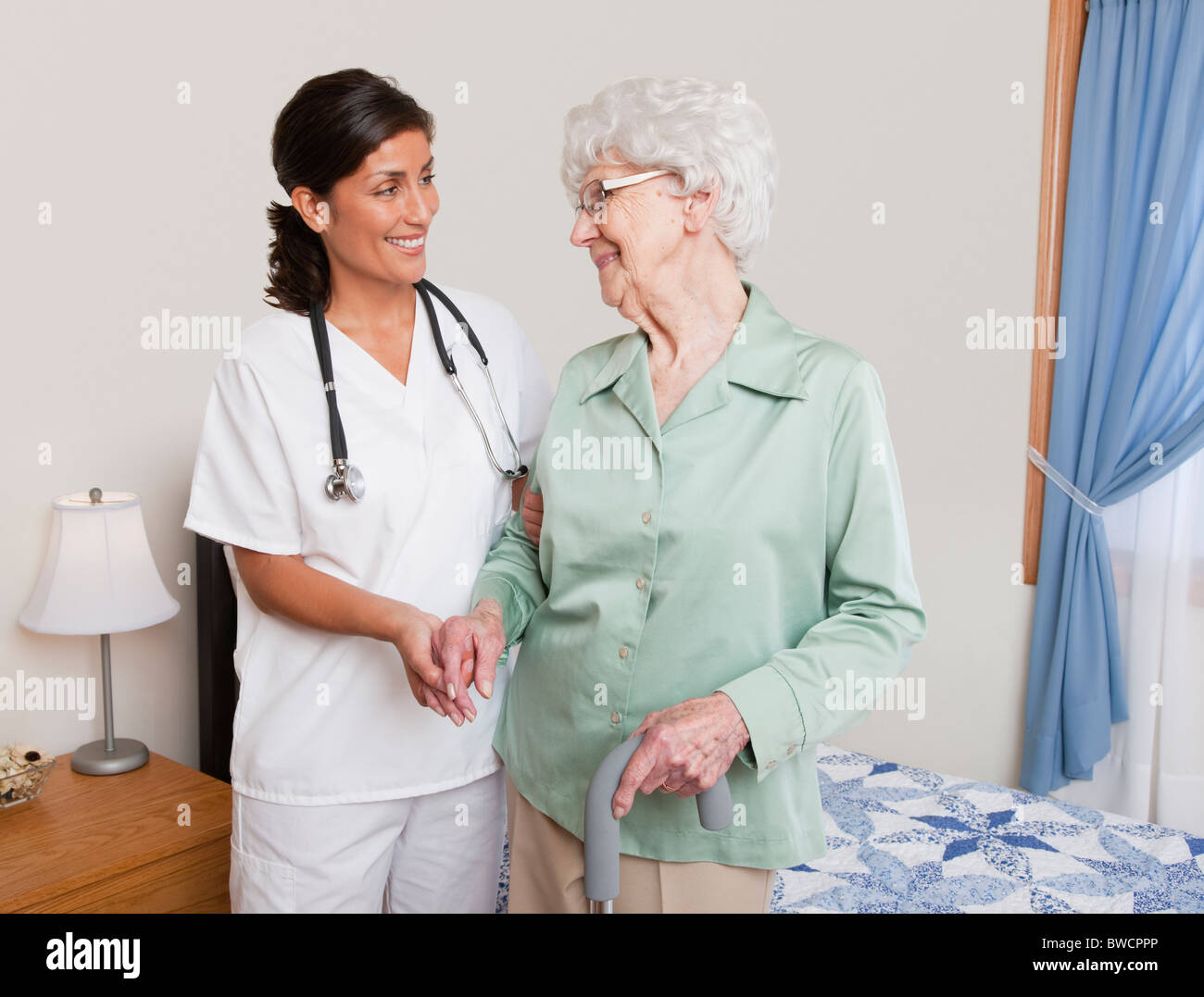 USA, Illinois, Metamora, Nurse helping senior woman with cane Stock Photo