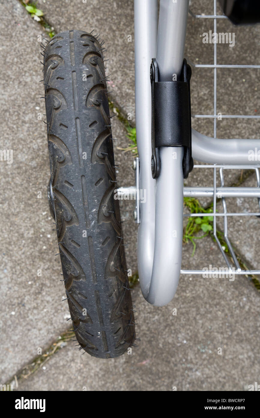 Damaged wheel on a baby pram. It got damaged during transit by a commercial airline. Stock Photo