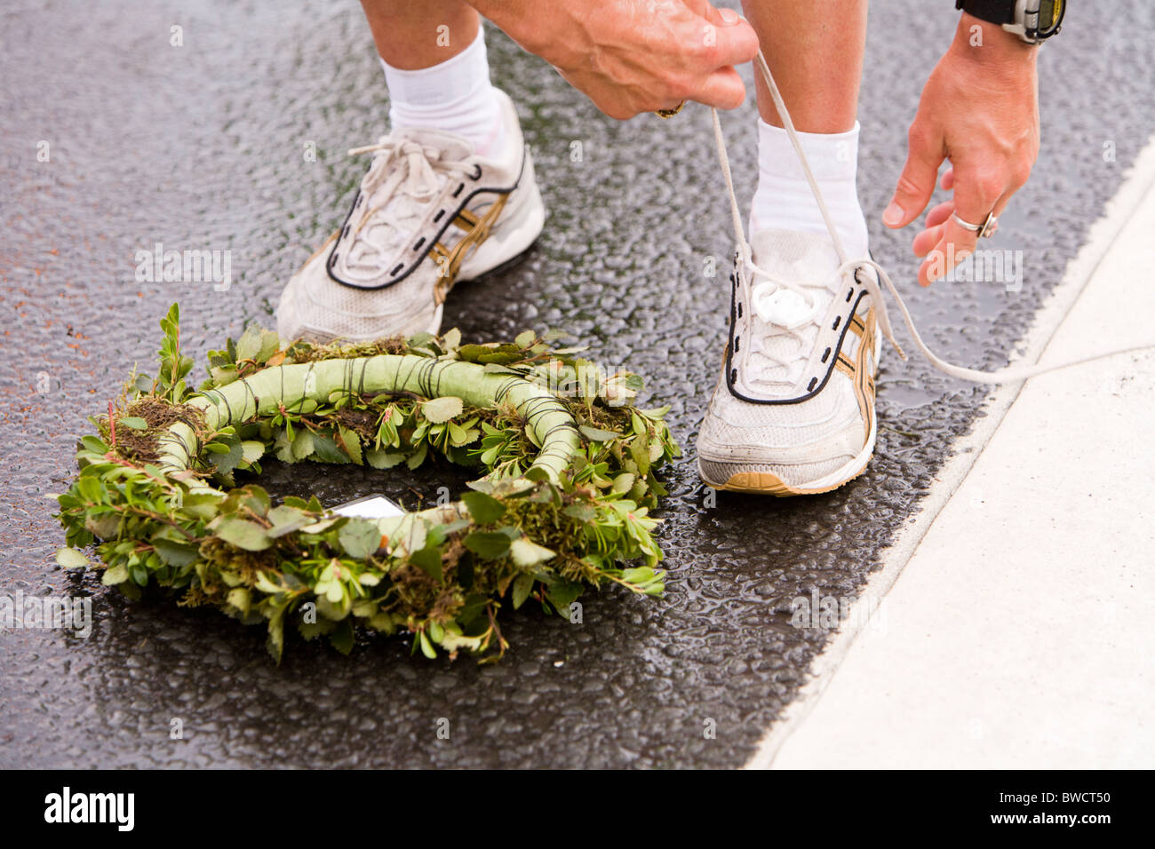 Martha Ernstdottir, winner, half-marathon, 2009 Reykjavik Marathon, Iceland. She is untying the time-tag from her shoe. Stock Photo