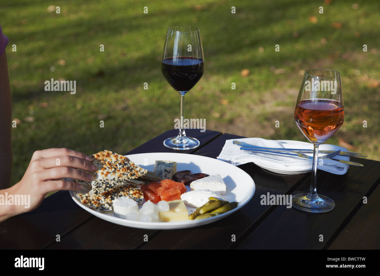 Woman with cheese platter and wine at Blaauwklippen Wine Estate, Stellenbosch, Western Cape, South Africa Stock Photo