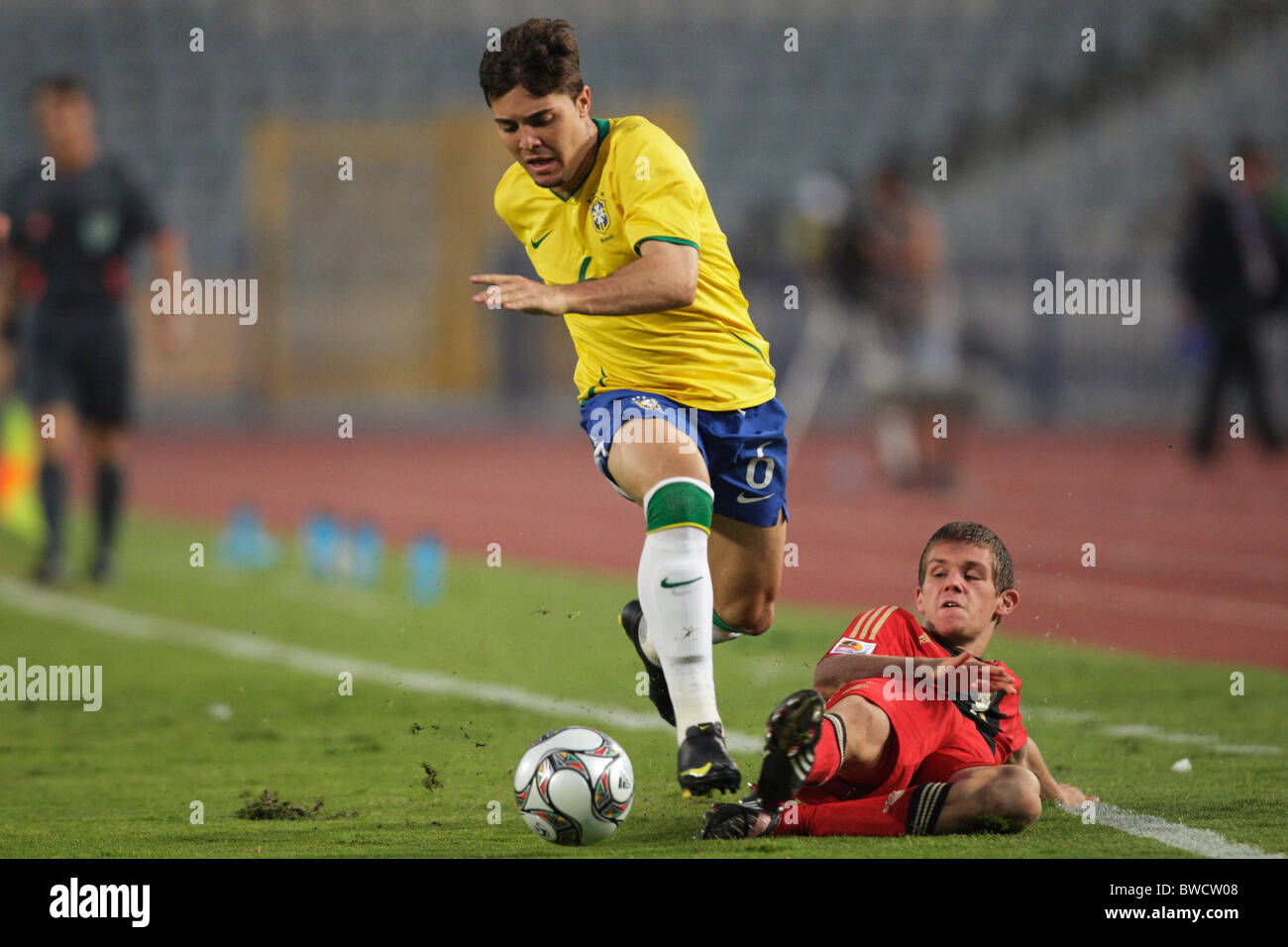 Diogo of Brazil (l) avoids a tackle by Sebastian Jung of Germany (r) during a 2009 FIFA U-20 World Cup quarterfinal match Stock Photo