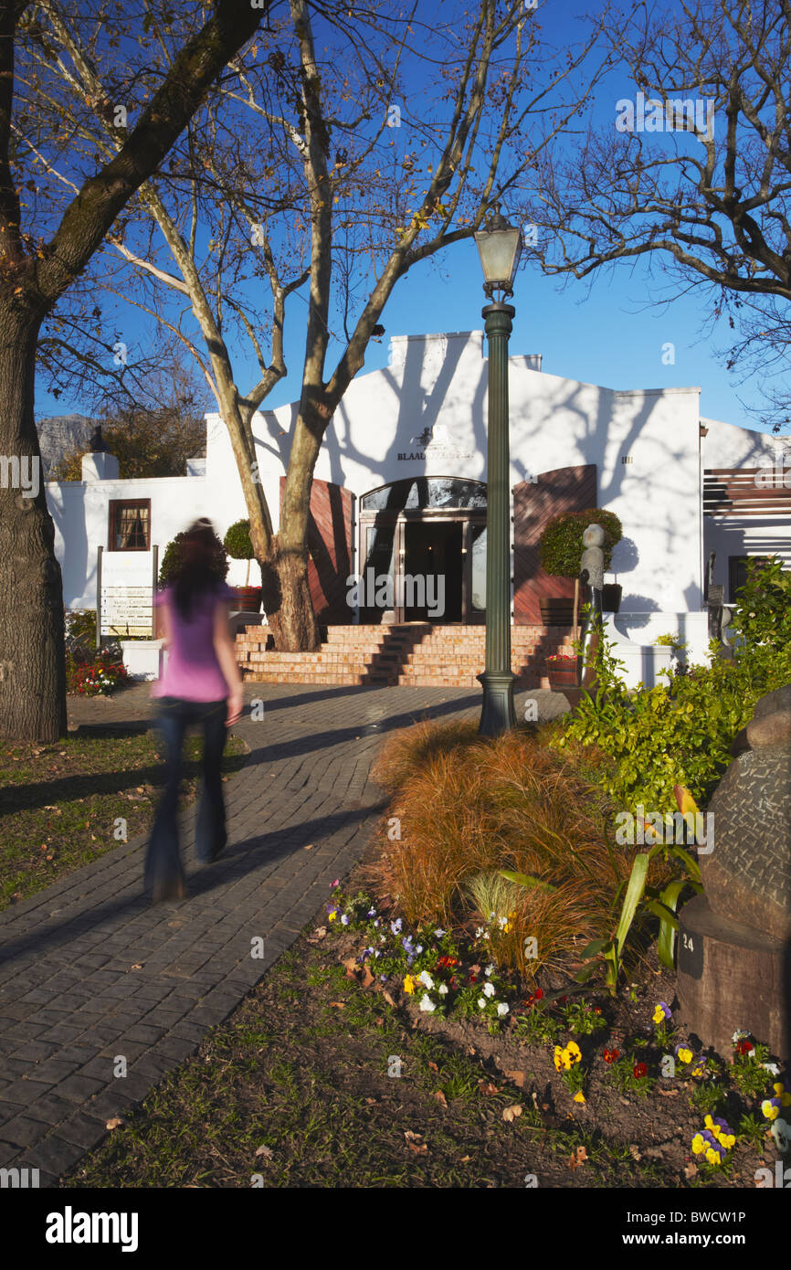 Woman walking to entrance of Blaauwklippen Wine Estate, Stellenbosch, Western Cape, South Africa Stock Photo