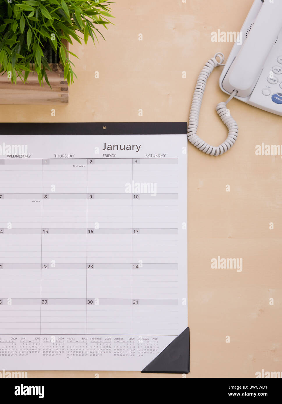 Wall calendar on desk Stock Photo - Alamy
