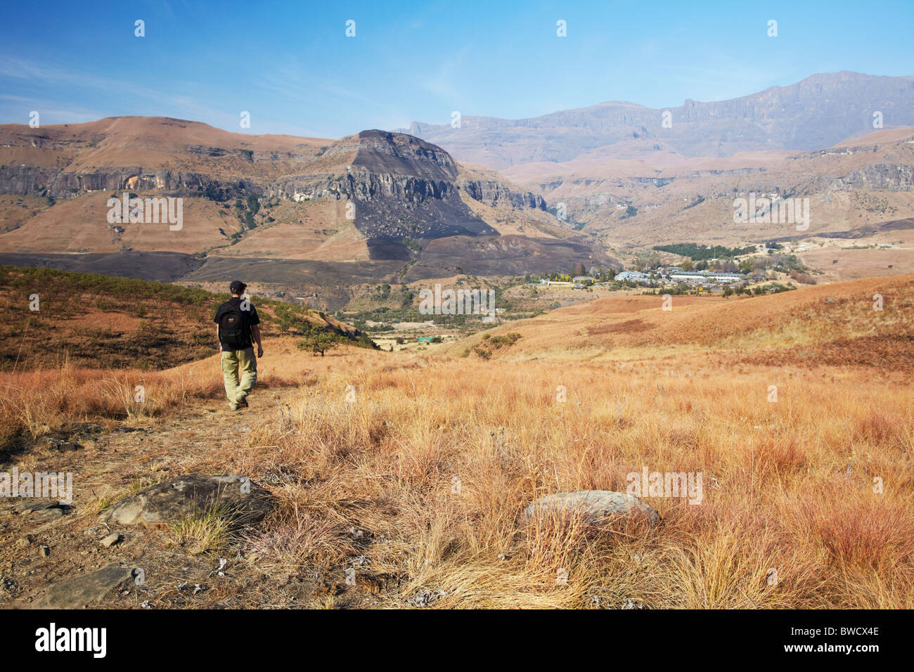 Man hiking in Cathedral Peak Nature Reserve, Ukhahlamba-Drakensberg Park, KwaZulu-Natal, South Africa Stock Photo