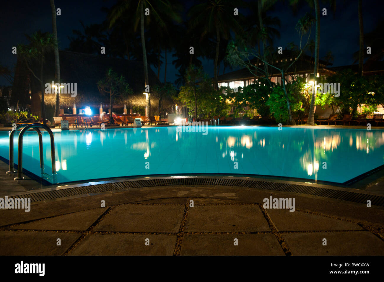 Ranweli Holiday Village swimming pool at night, Sri Lanka Stock Photo -  Alamy