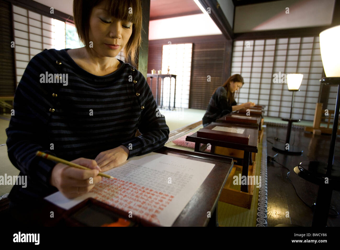 Women handwriting Buddha sutra at Unryu-in temple Kyoto city Japan Stock Photo