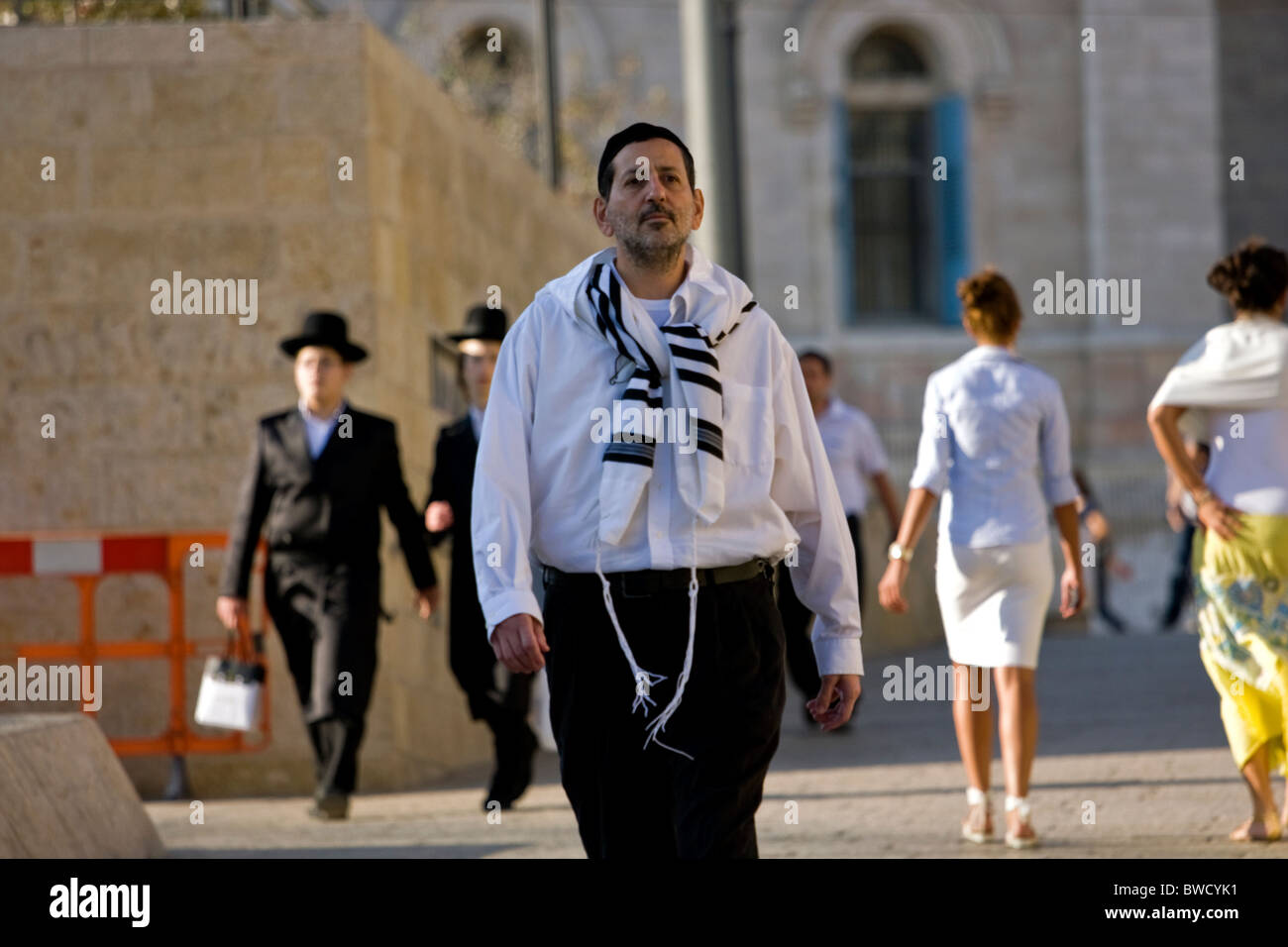 Jewish people dressed in traditional religious clothes go to the