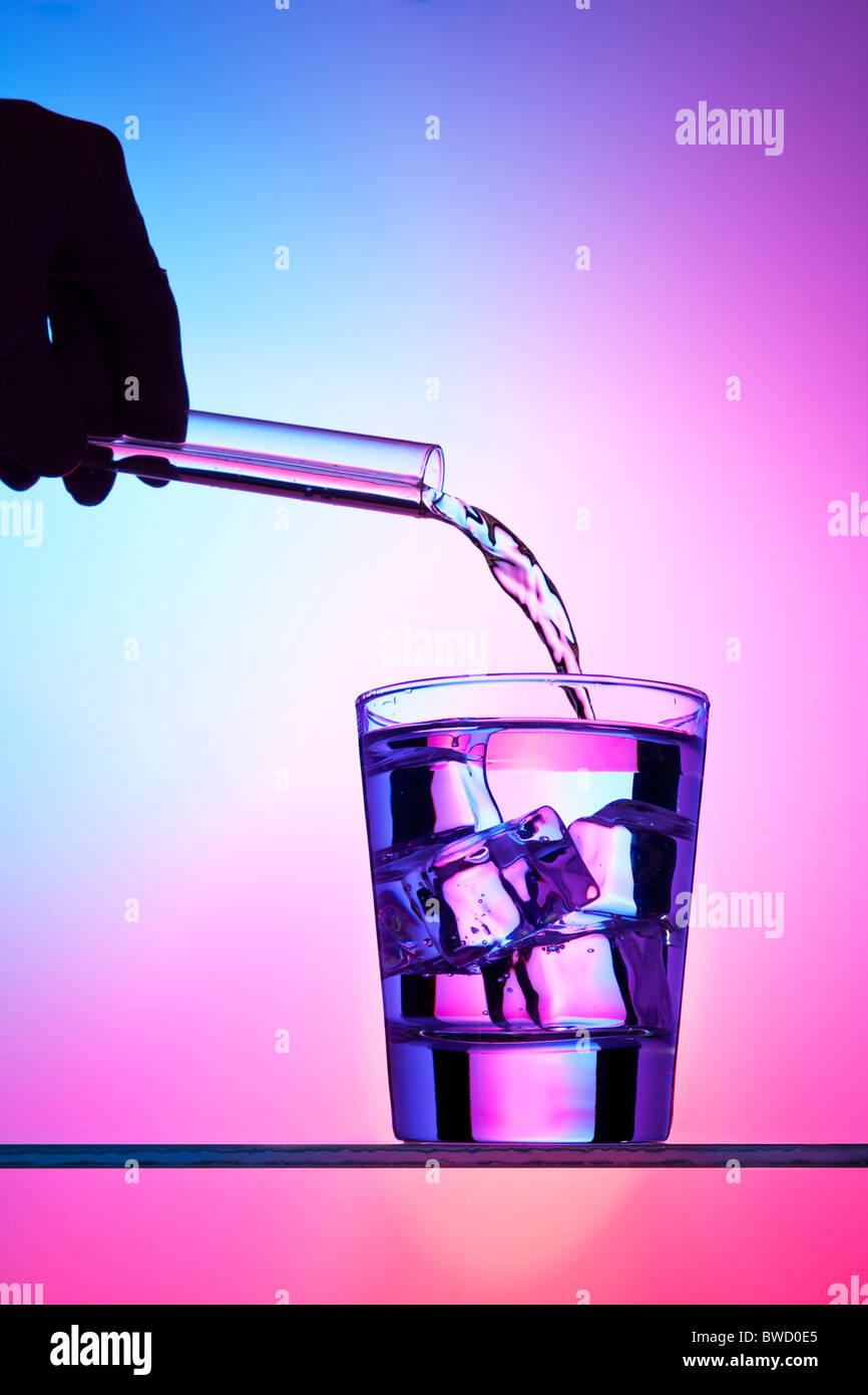 Pouring liquid from a test tube into a cocktail Stock Photo Alamy