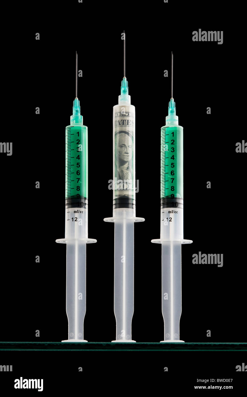 Syringes one filled with a one dollar bill Stock Photo Alamy