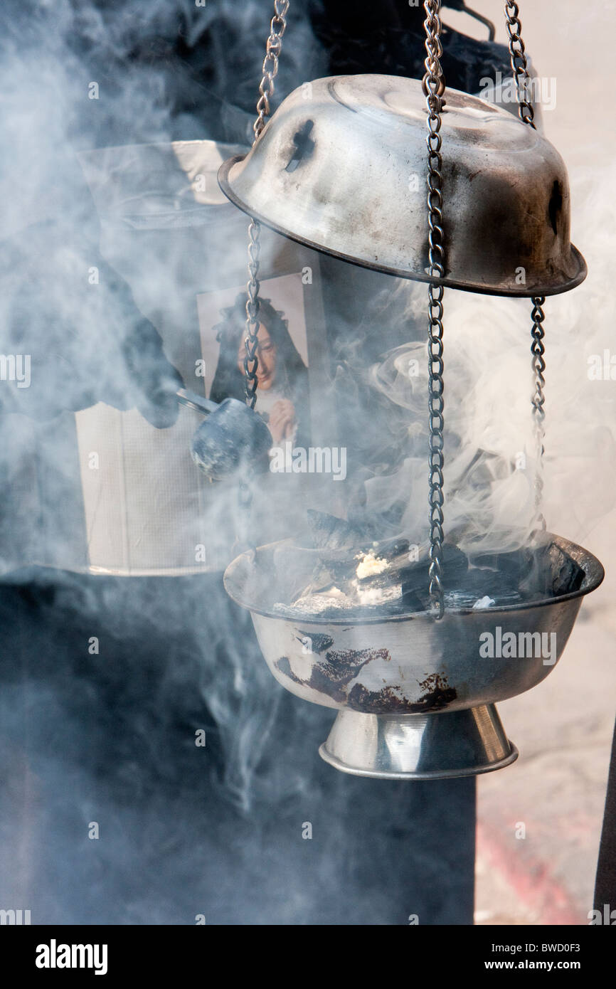 Antigua, Guatemala. Adding Incense to Incense Burner in the Procession