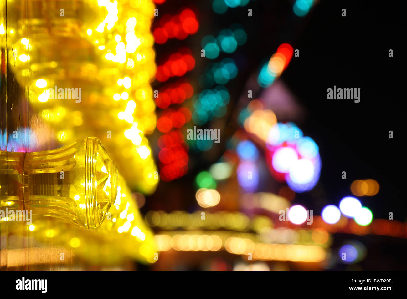 A close up shot of some colourful lights on one of the many fairground