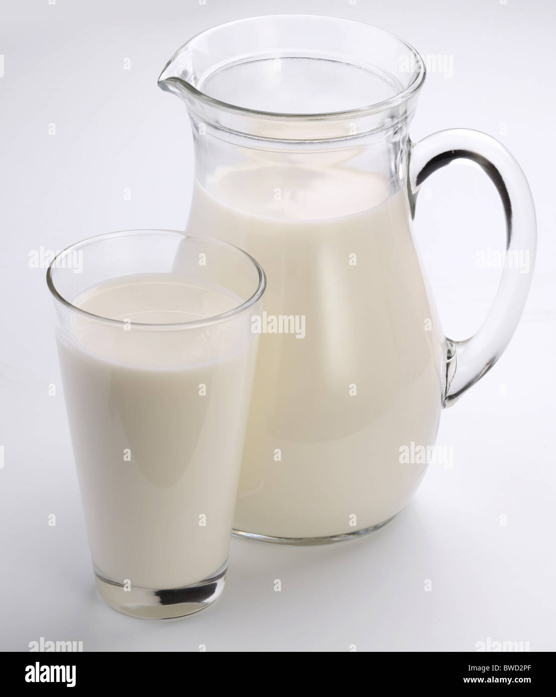 Glass and jar of milk on a white background. Stock Photo