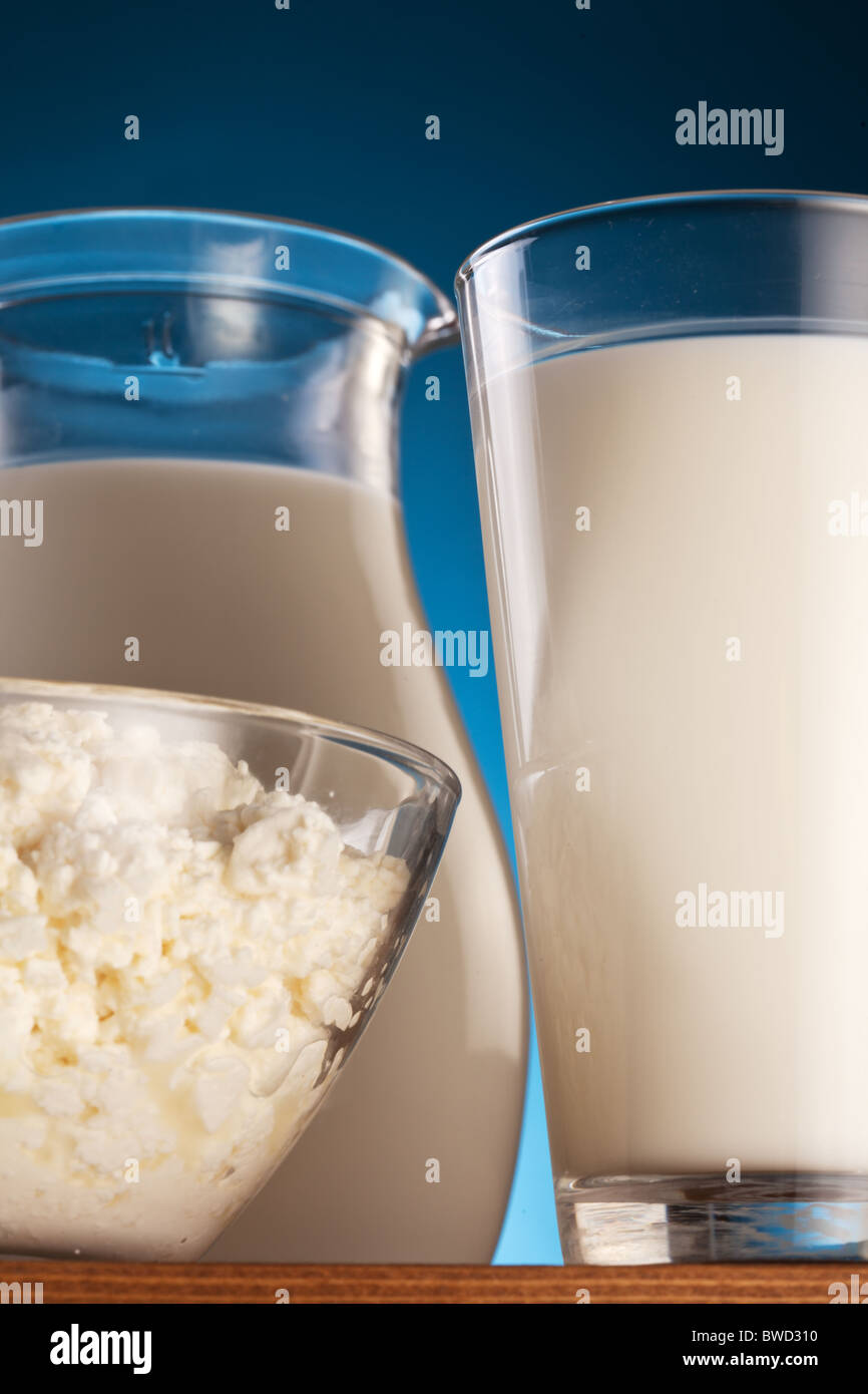 Jar and glass with milk and bowl with cottage cheese. Isolated on a