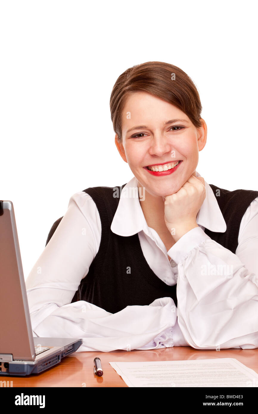 Young happy business woman sits on desk in office. Isolated on white background. Stock Photo