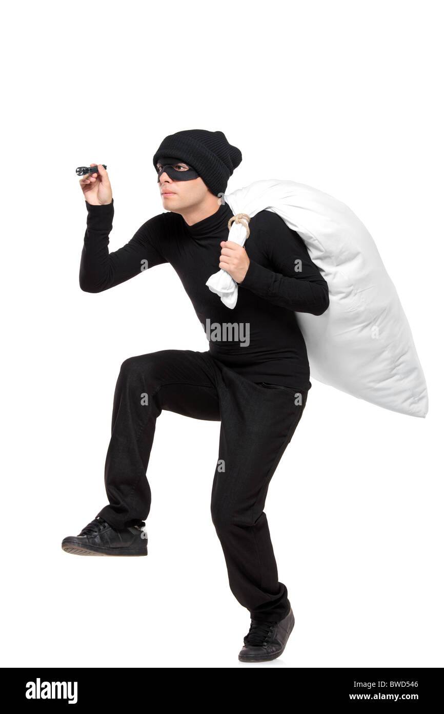Full length portait of a robber with a bag and flashlight in hands Stock Photo