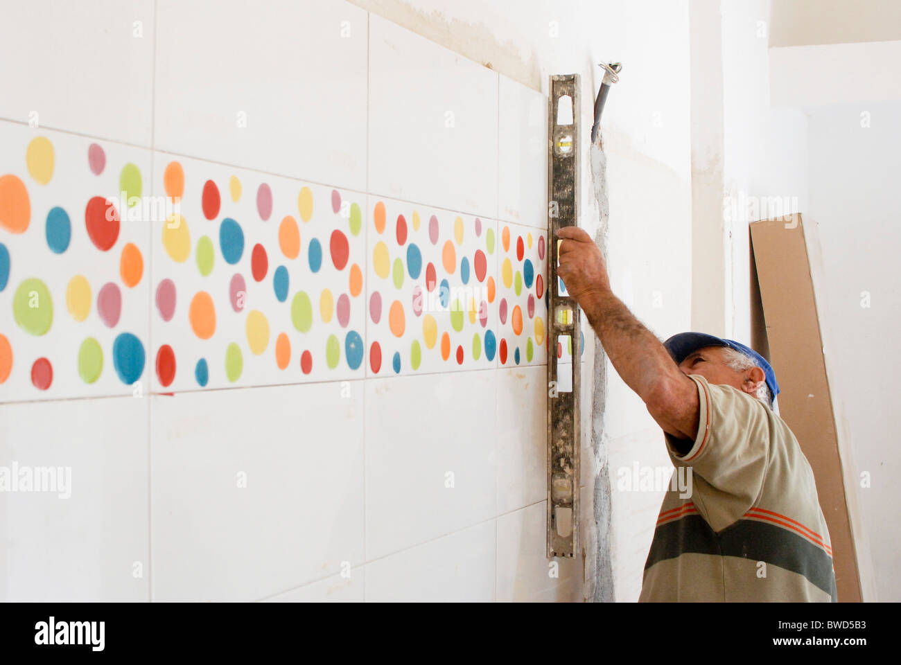 skilled Tiler at work laying tiles Stock Photo Alamy