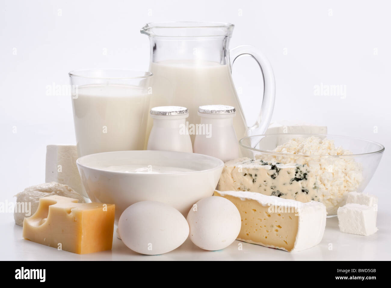 Protein products: cheese, cream, milk, eggs. On a white background. Stock Photo