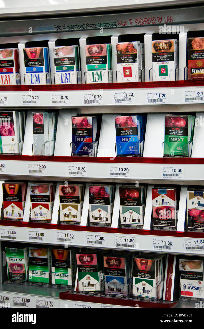morbid graphic cigarette packages at convenience store in Singapore Stock Photo