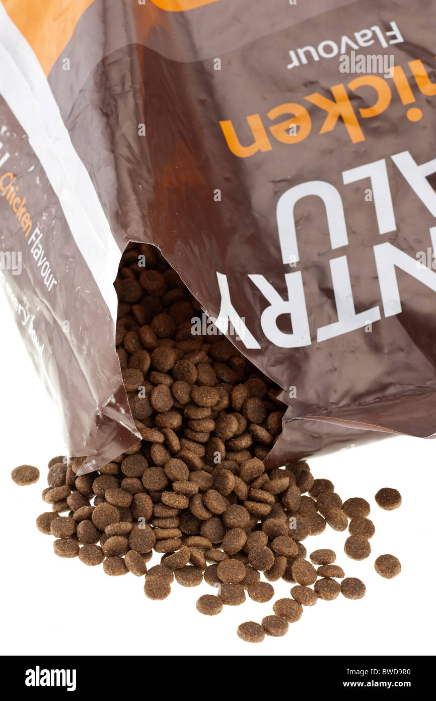 Brown complete dog biscuit food spilling from a 15 kg plastic sack Stock Photo Alamy