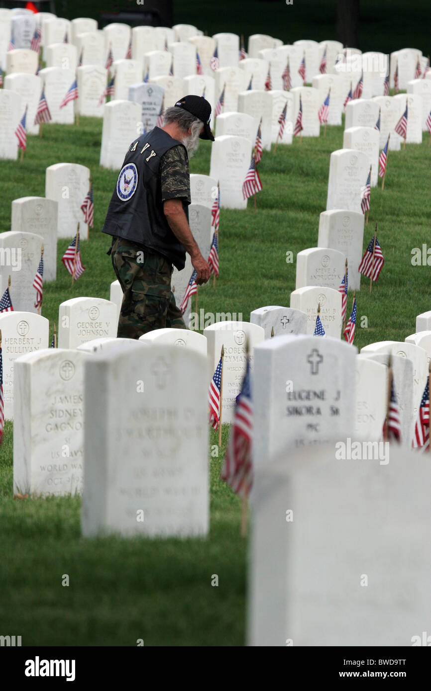 A Navy veteran walking through the grave sites covered with American flags at Clement J Zablocki Veterans Cemetery Wisconsin Stock Photo