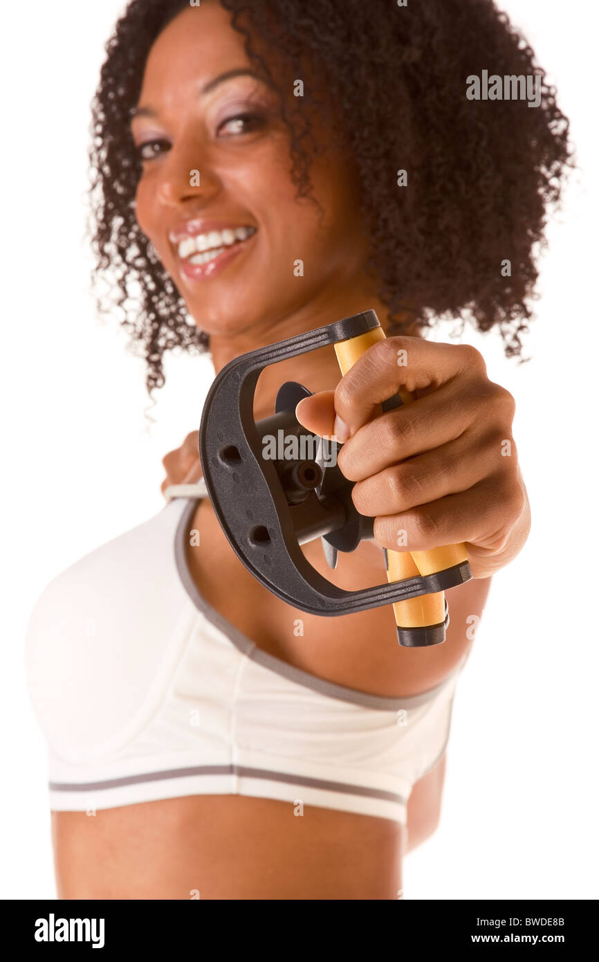 Dark skinned woman stretching using rubber band (selective focus on hand) Stock Photo