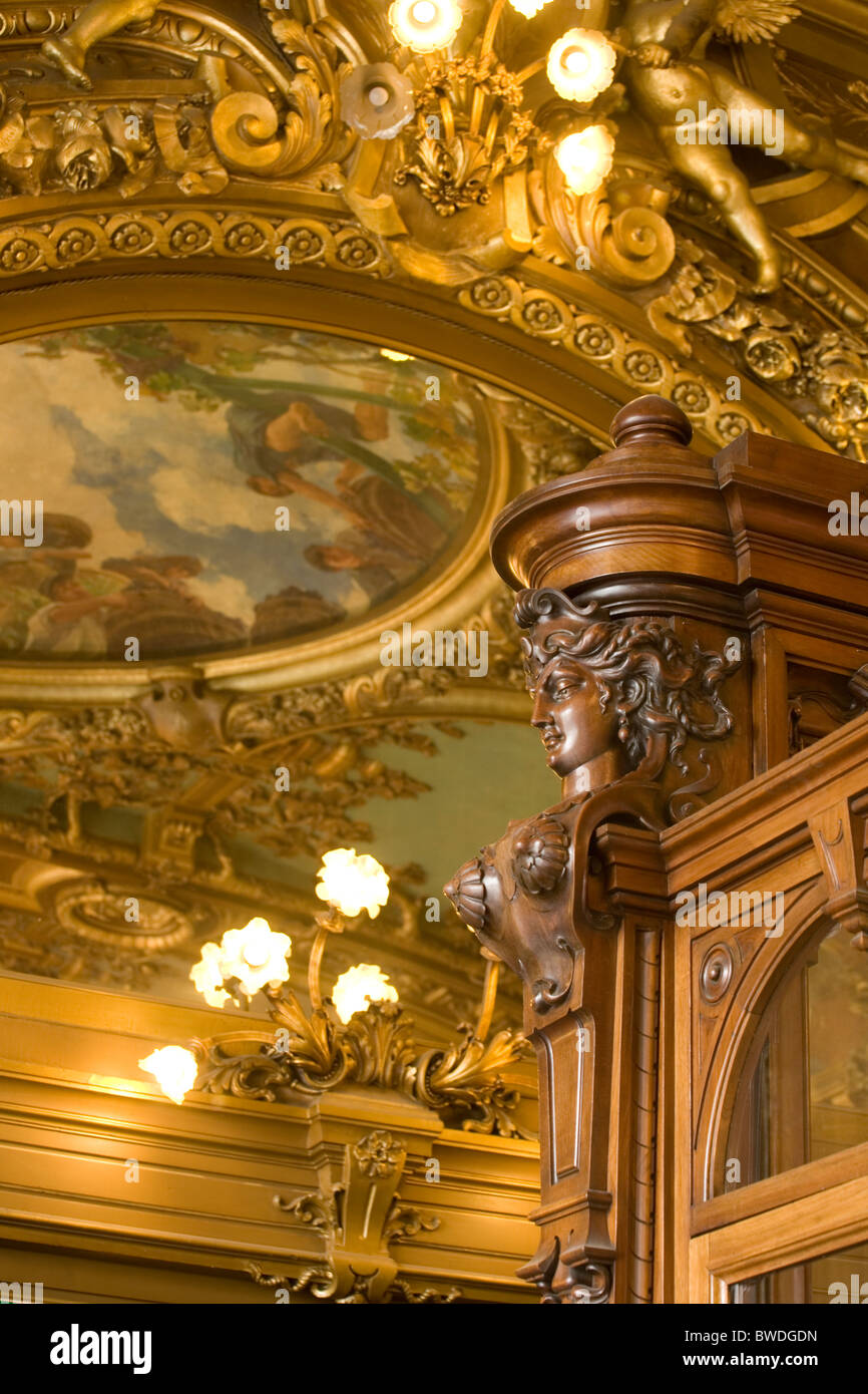 elaborate ceiling decoration in le train bleu restaurant in the gare de