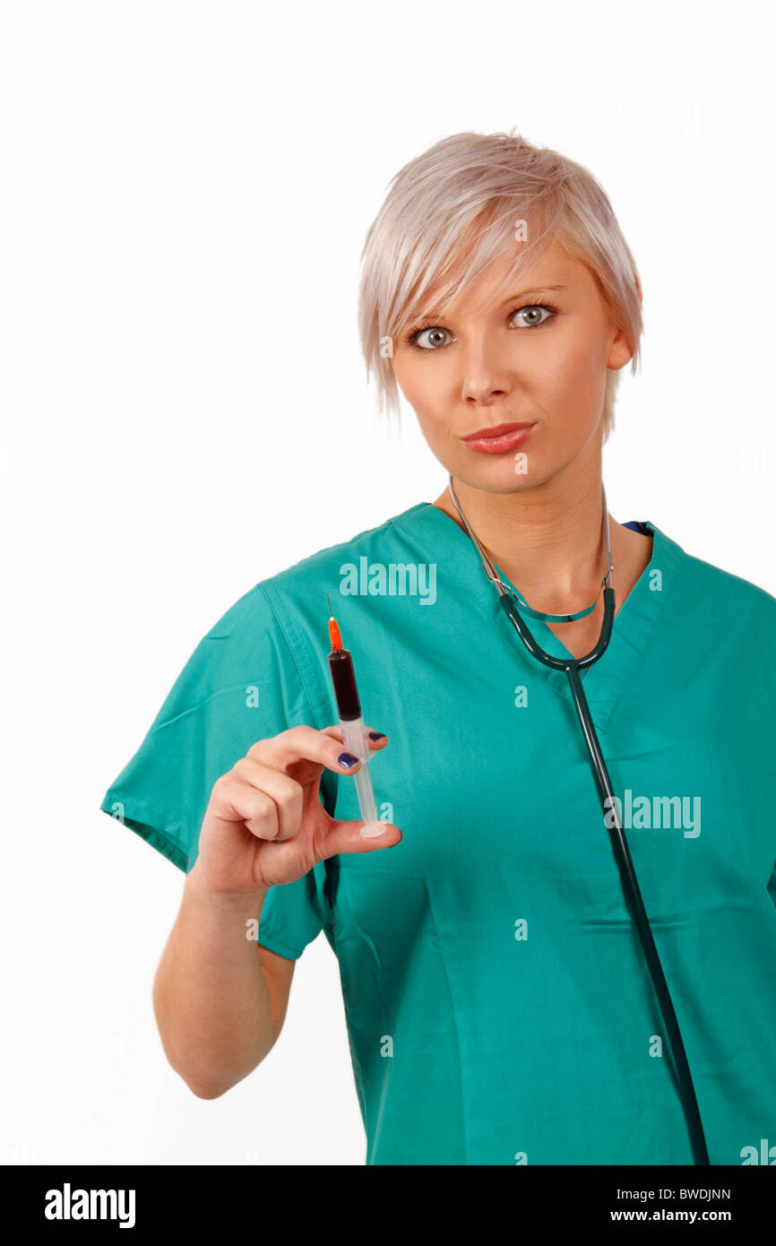 young medic holding a syringe full of blood Stock Photo