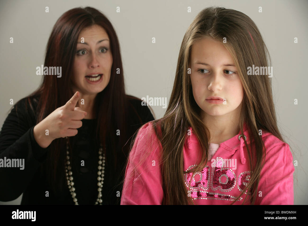 Mother telling off her ten year old daughter. Stock Photo