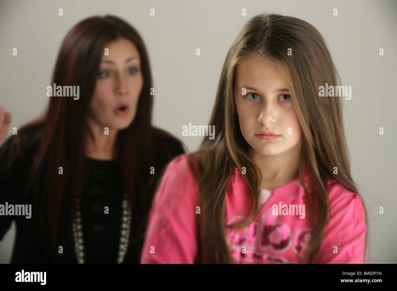 Mother telling off her ten year old daughter. Stock Photo