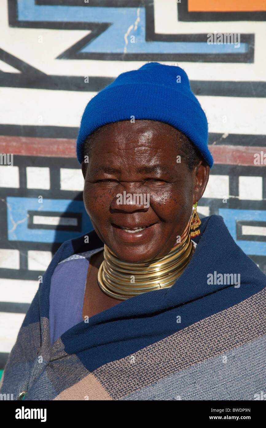 Traditional Ndebele Woman in Neck Rings with Ndebele Murals, Kwandebele Area, South Africa Stock Photo