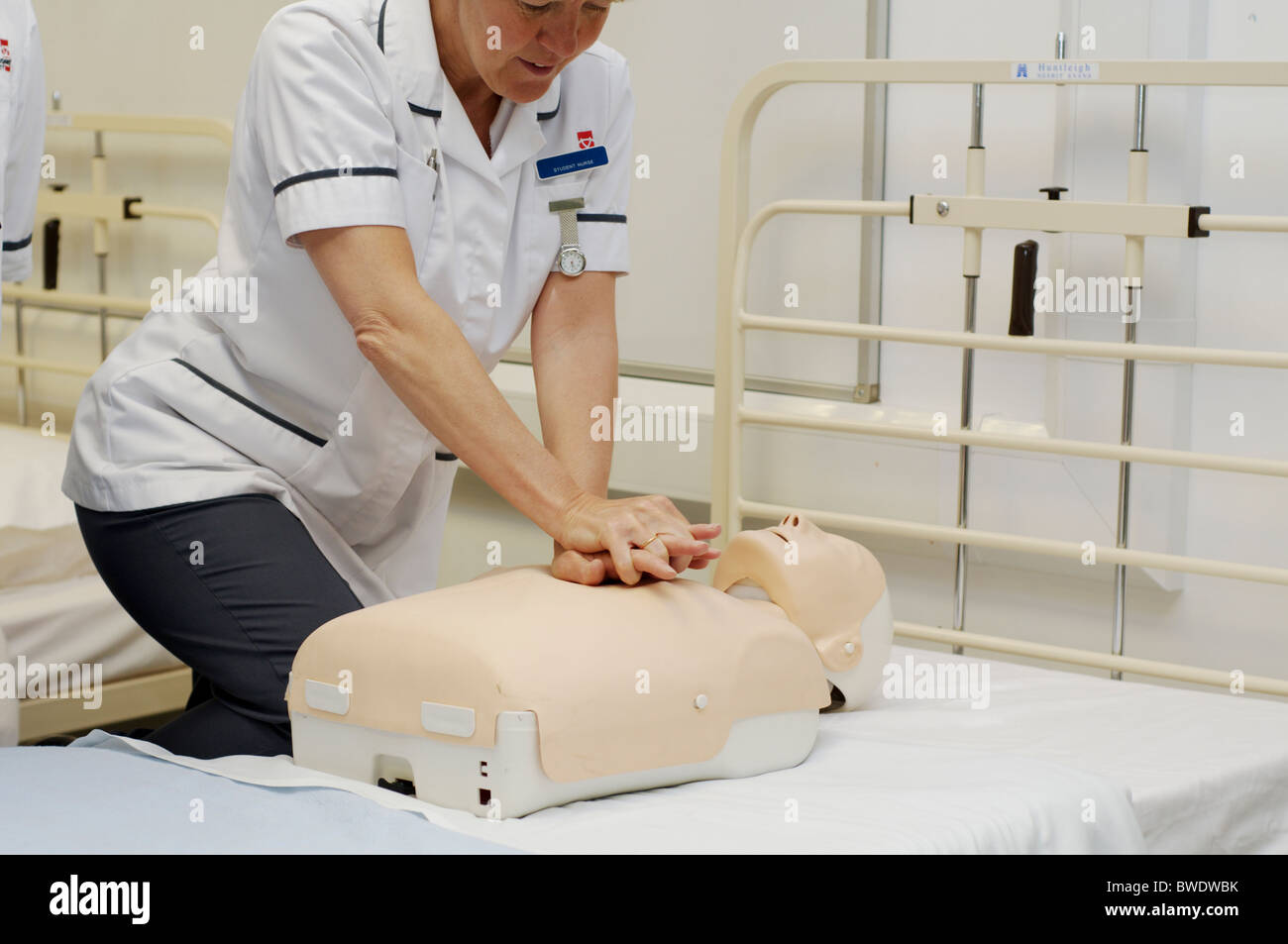Nurse practises resuscitation on a dummy in a teaching hospital ward Stock Photo