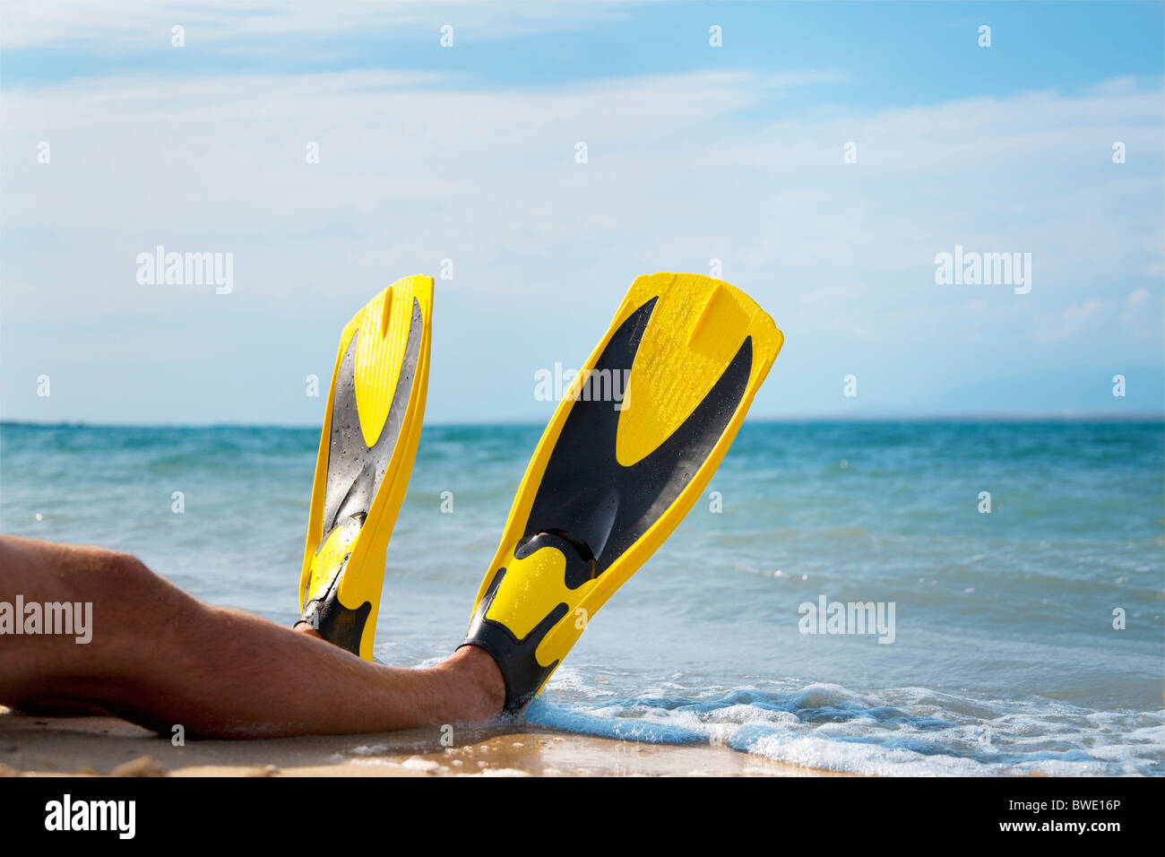 Man with flippers at the beach Stock Photo