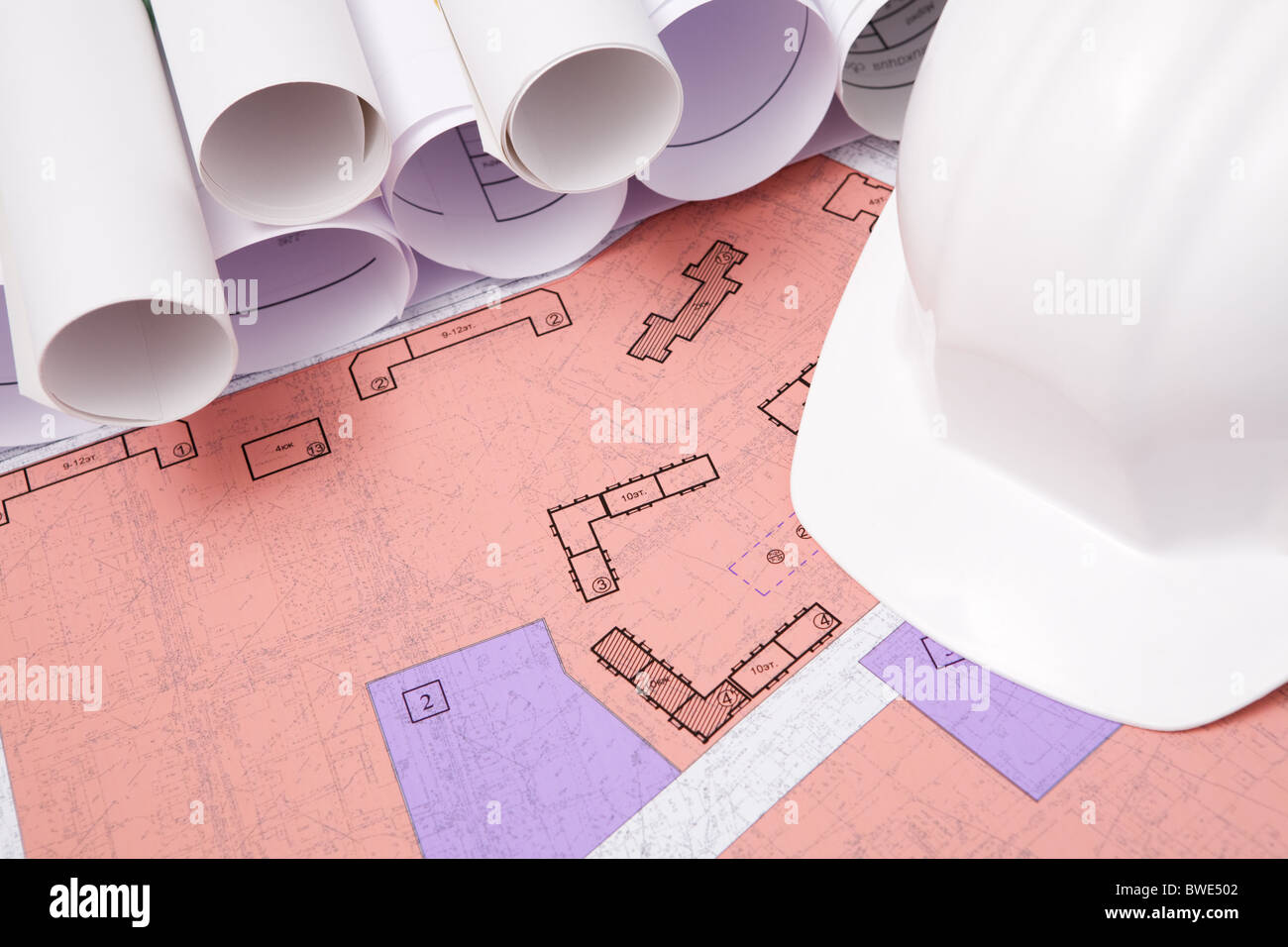 Close-up of blueprints and helmet on workplace Stock Photo - Alamy