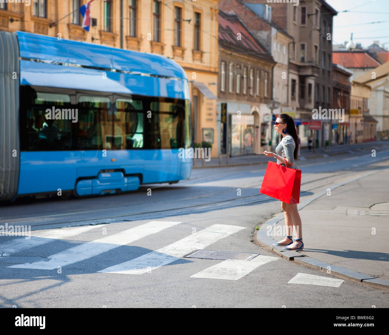 Young woman crossing road Stock Photo