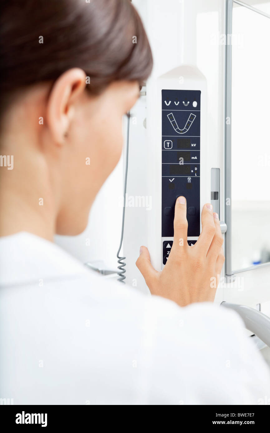 A detail of a young woman using a panormaic digital X-ray machine Stock Photo
