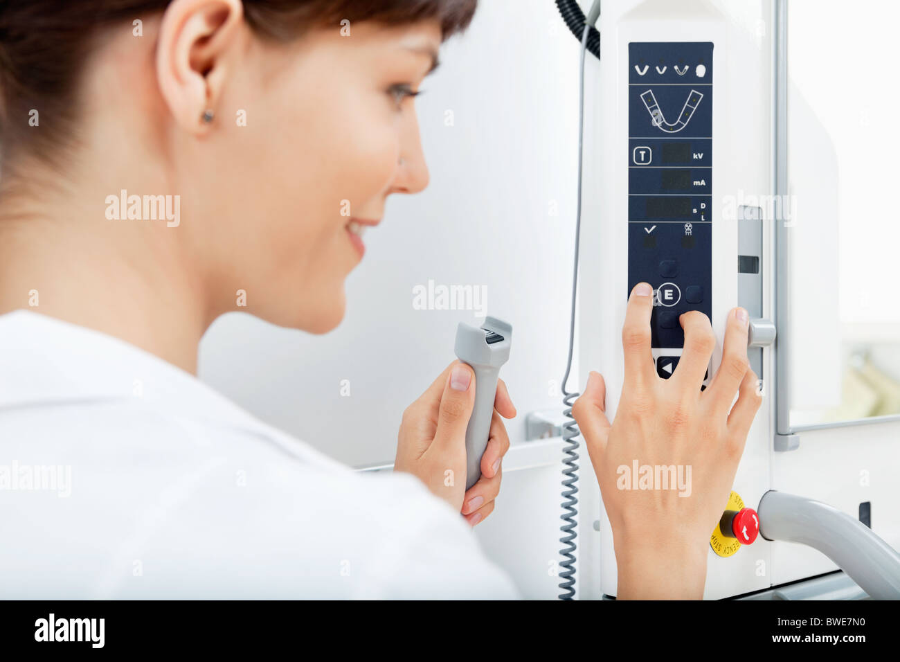 Closeup of a young female orthodontist adjusting the controls on a Panoramic Imager Stock Photo