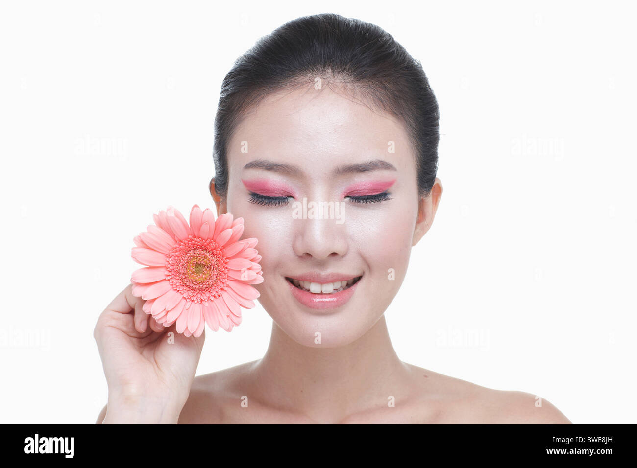 woman is closing her eyes holding blossom Stock Photo - Alamy