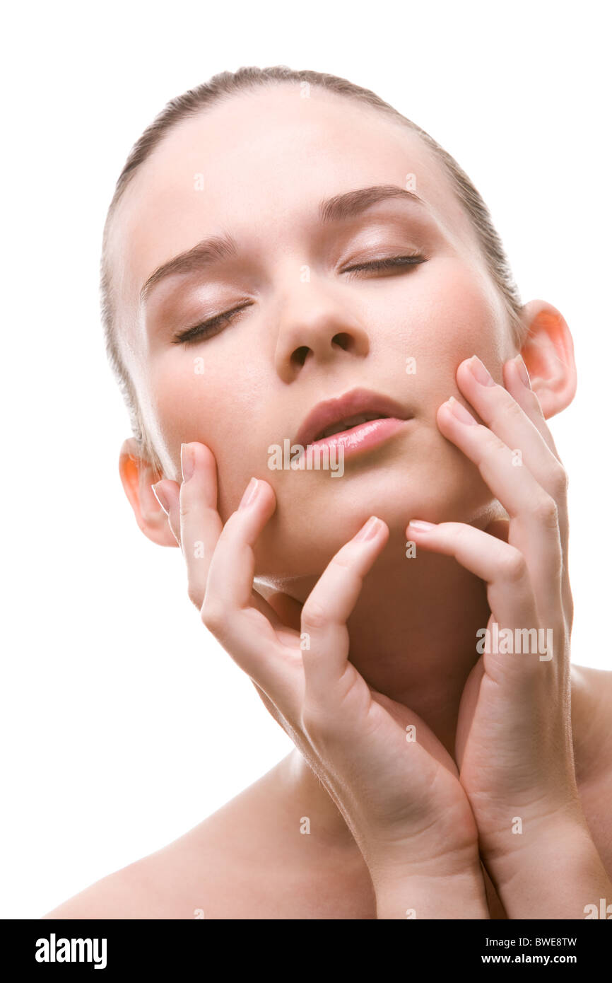 Close-up of pretty young woman with closed eyes touching her face Stock ...