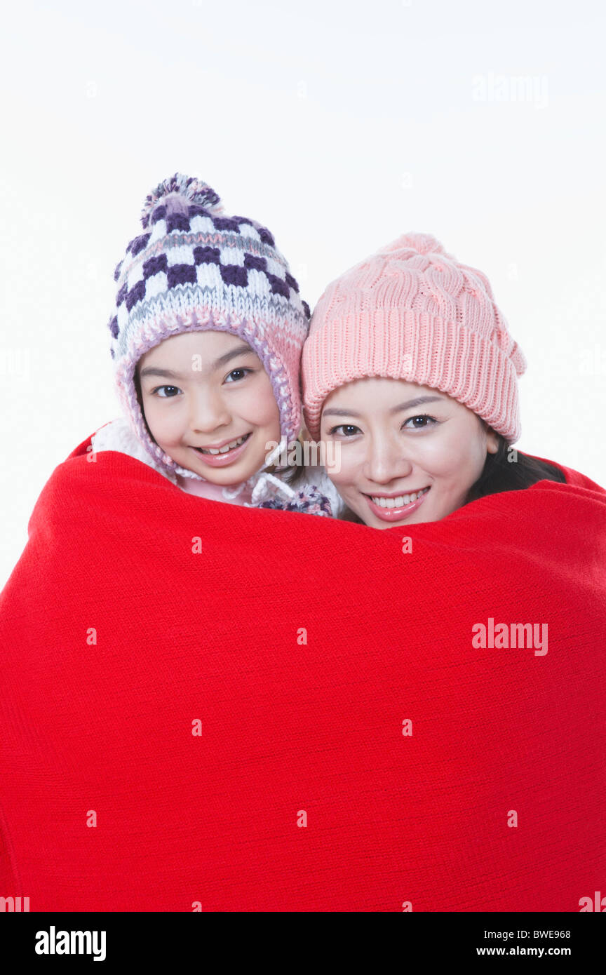 mother and daughter is covering with the red blanket Stock Photo Alamy