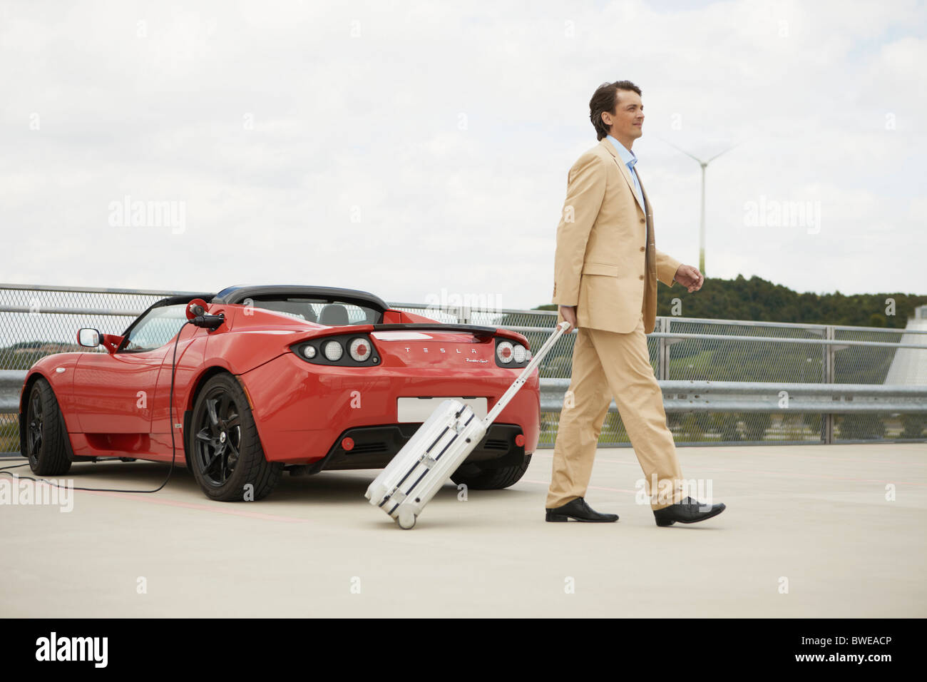 Man walking trolley electric car hires stock photography and images