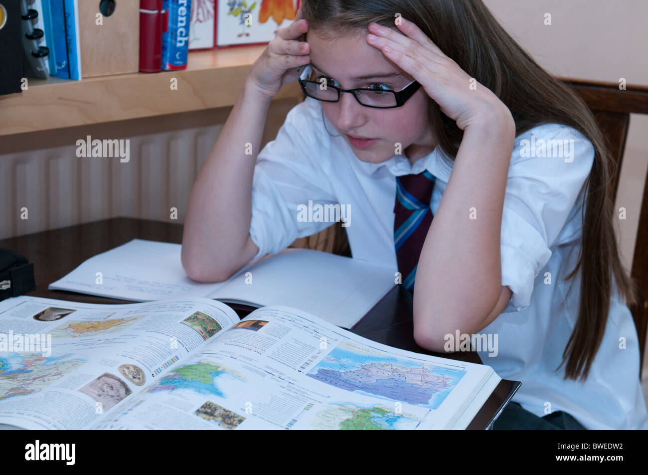 Young girl trying to do her homework revision and getting stuck Stock ...
