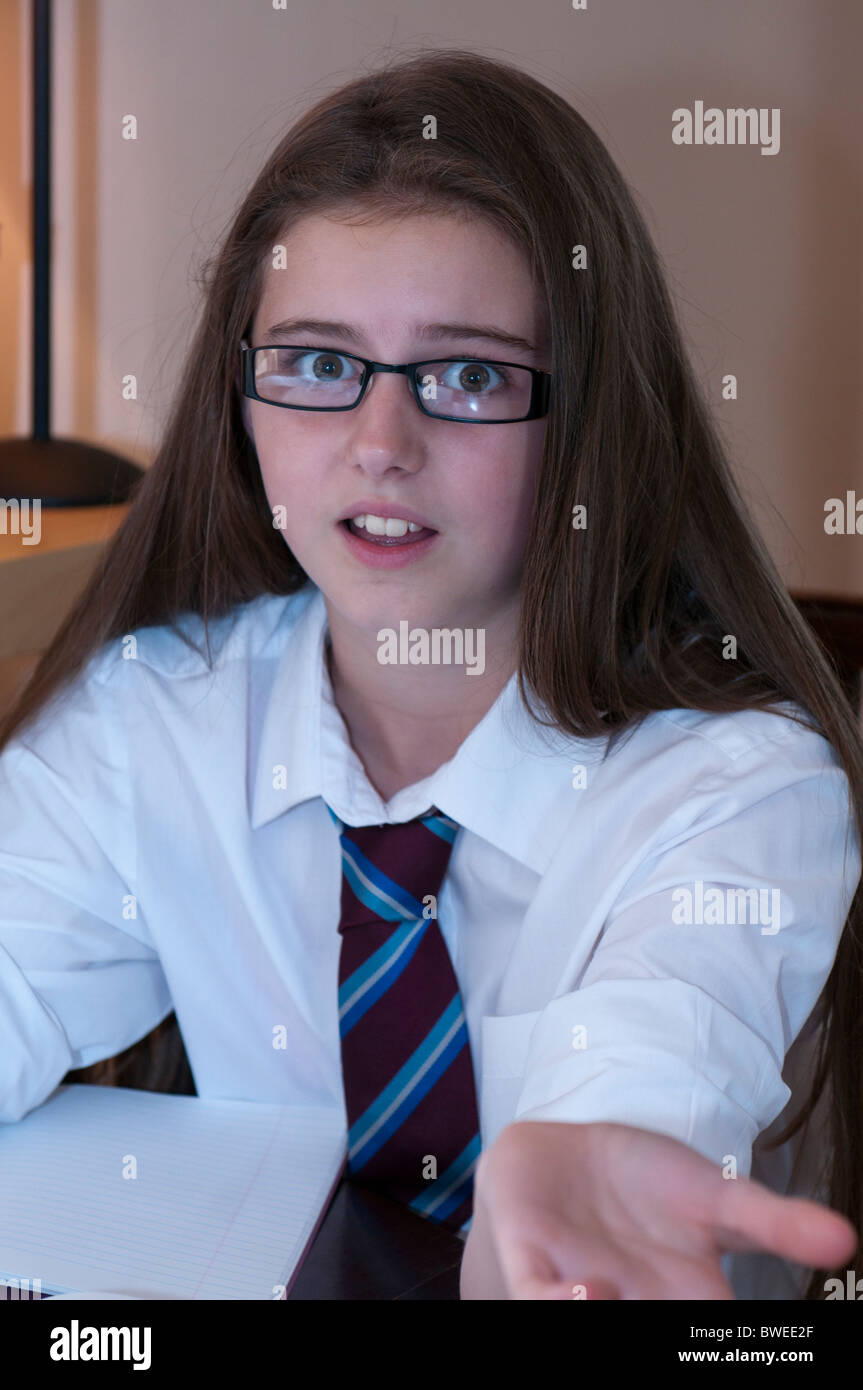 Young girl in school uniform and glasses looking overwhelmed at camera  Stock Photo - Alamy