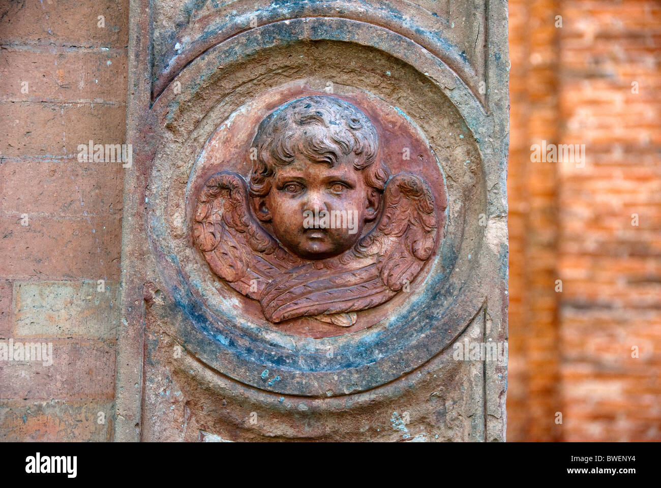 Detail of an angels face in a rondel in the gate of the cimitero della Certosa, or Cemetery of Certosa, Ferrara matches BWEP6D Stock Photo