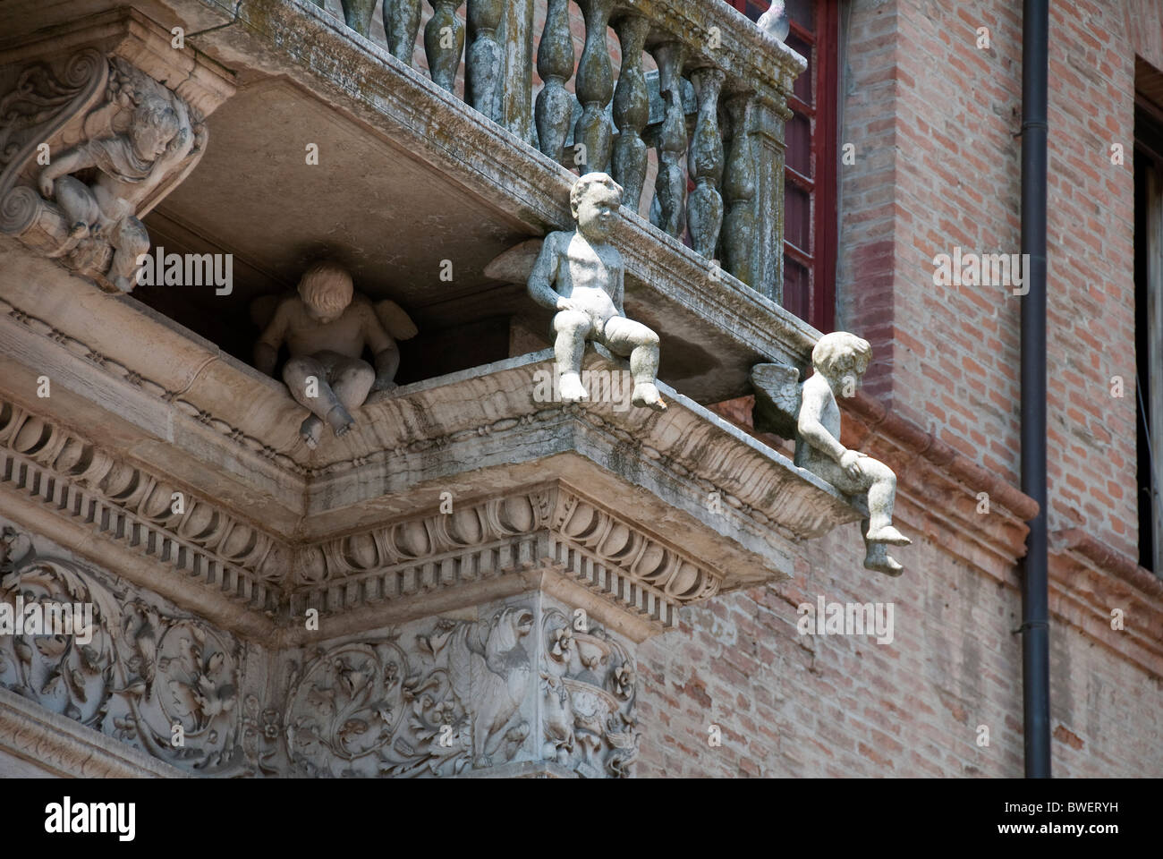 Balcony with sculptured details of children on the facade of Palazzo Prosperi-Sacrati, Ferrara Stock Photo