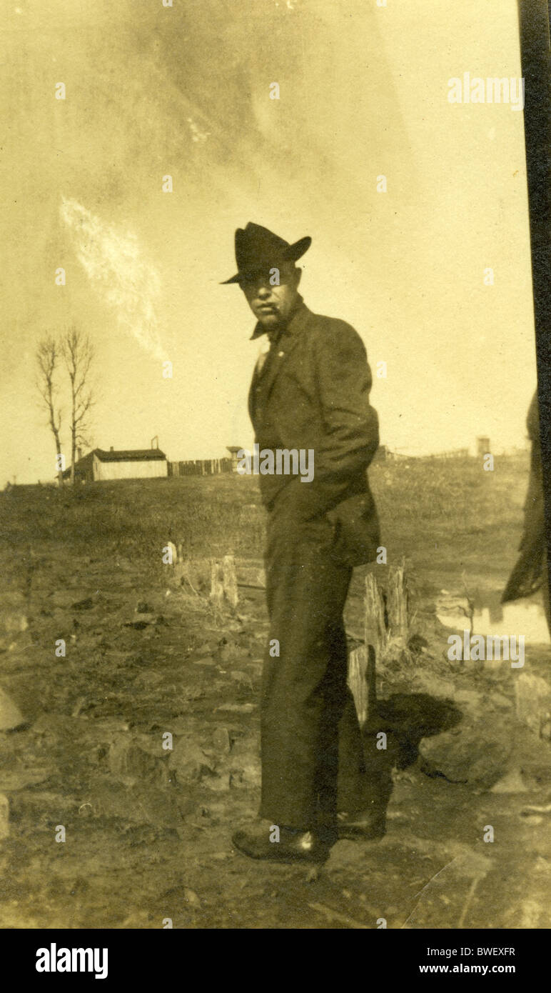 man with hat 1910s americana black and white vertical fashion coat winter  Stock Photo - Alamy