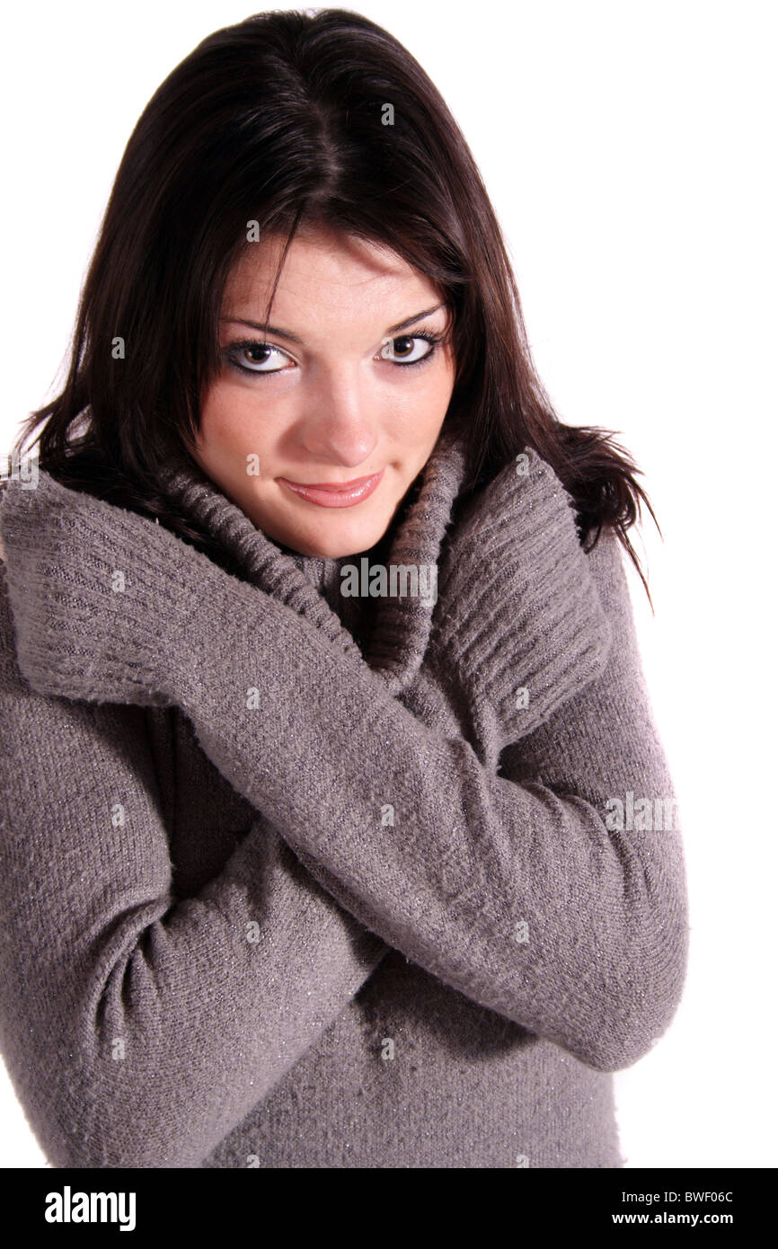 A handsome young woman freezing. All isolated on white background. Stock Photo
