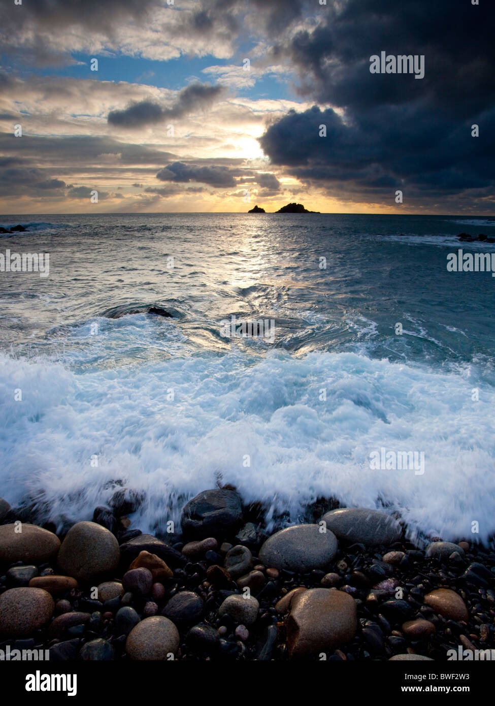 Sunset over the small islands known as the Brisons from Priests Cove, Cornwall England UK Stock Photo